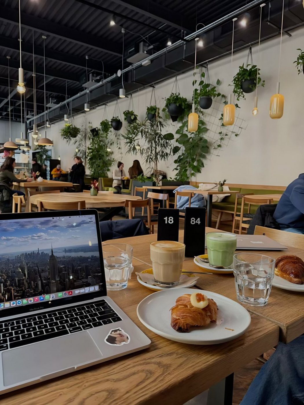 Working on a laptop with coffee and croissant